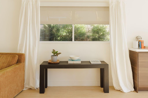 Window shades as one of the window treatment ideas for the living room.