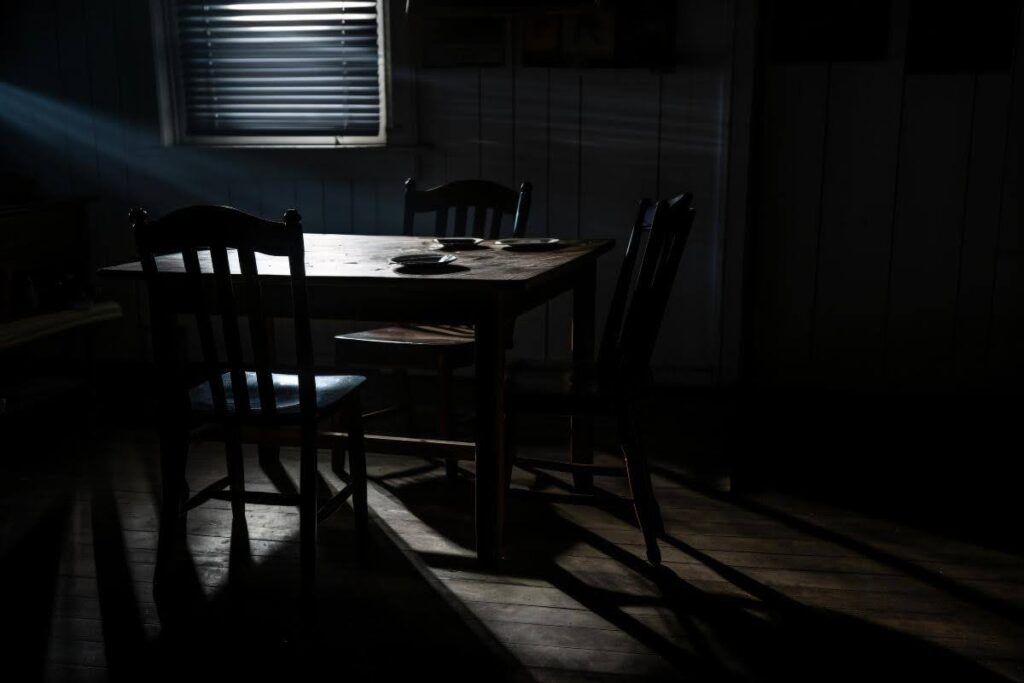 Blinds filtering daylight to darken a room.