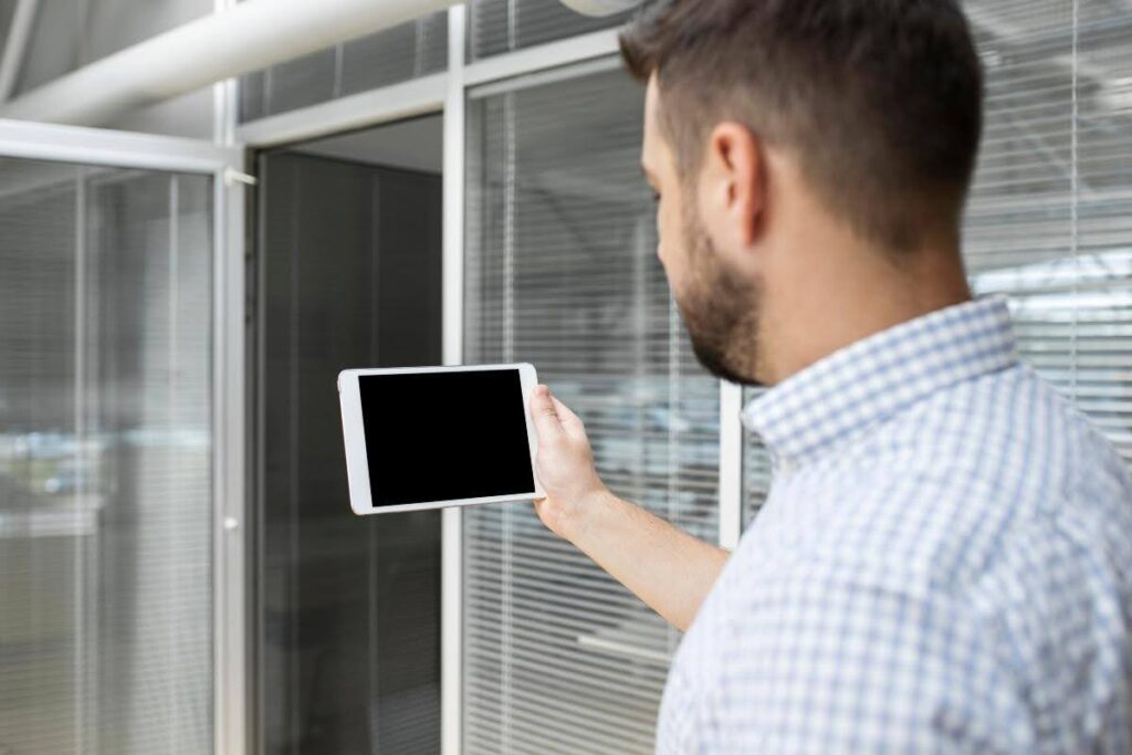 A man checking how to reset motorized shades.