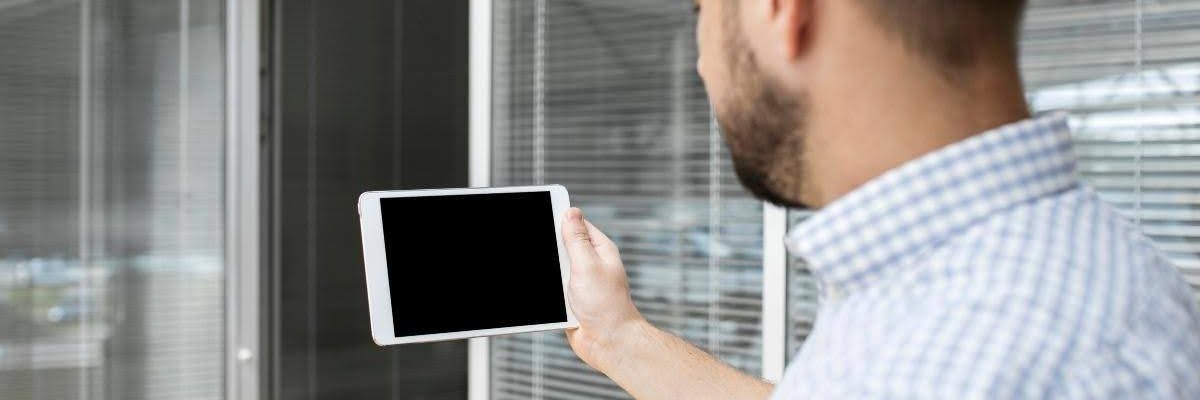 A man checking how to reset motorized shades.