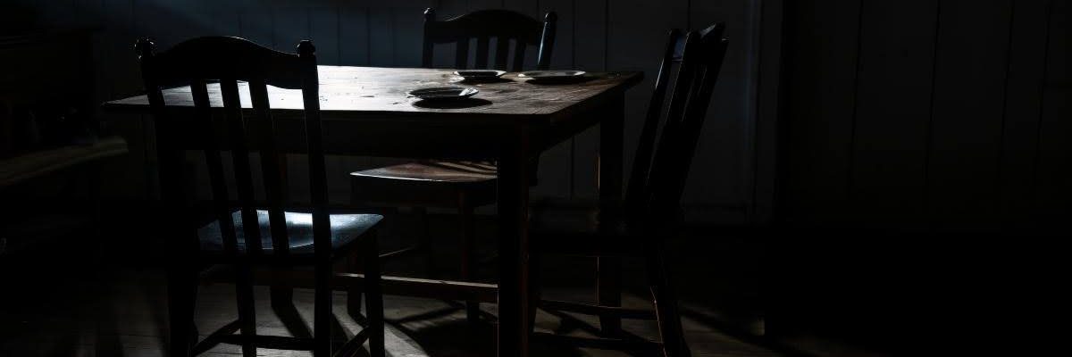 Blinds filtering daylight to darken a room.