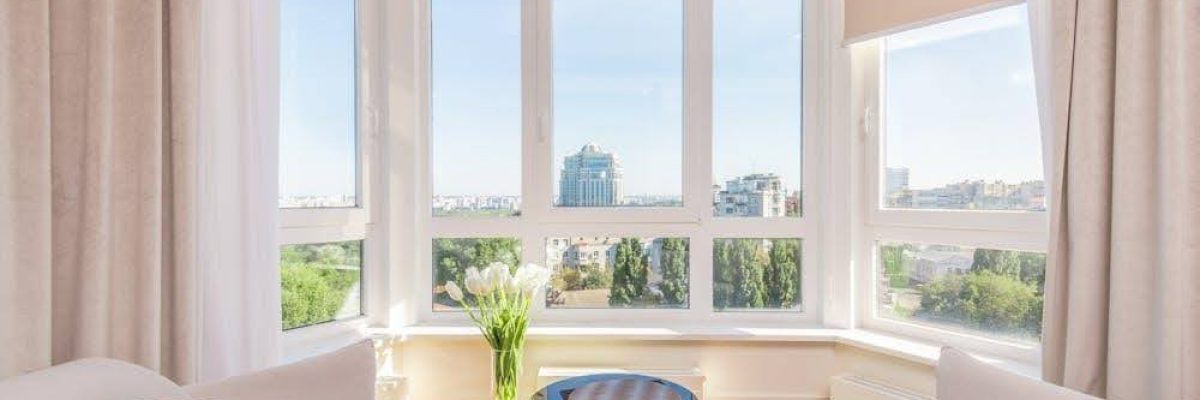 A bright living room with large windows dressed in stylish window treatments.