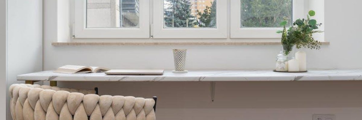 A bright room with a triple-pane window partially covered by blackout shades.